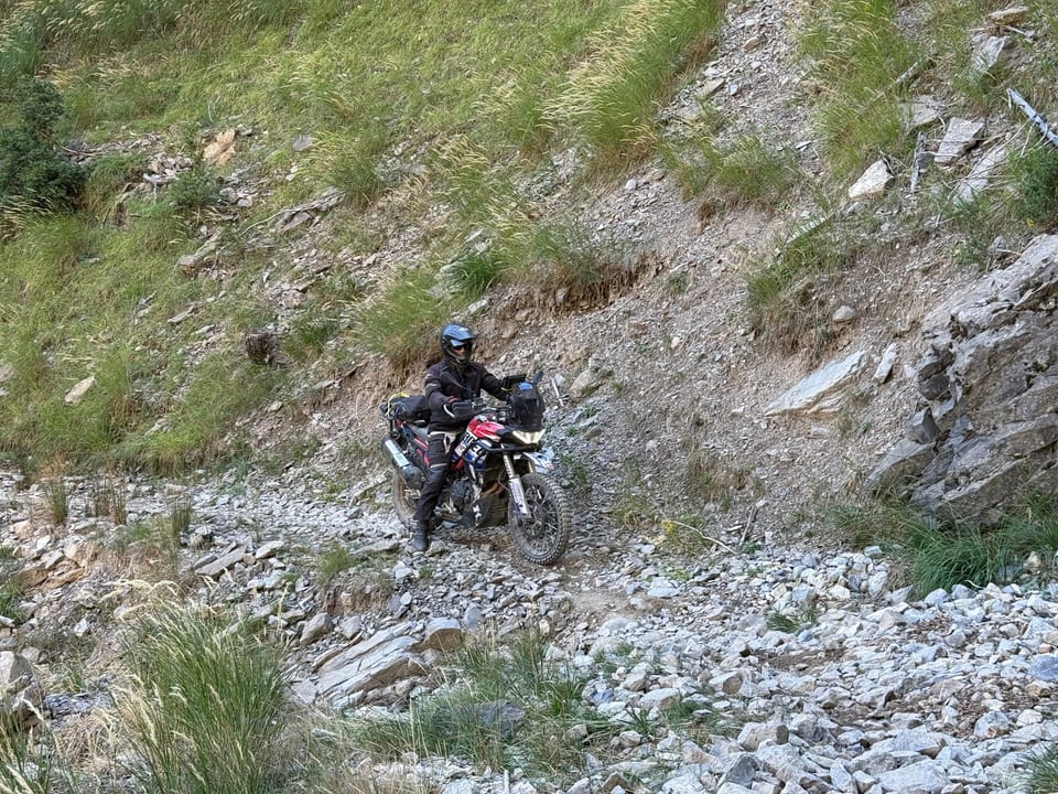 Loose rock across the slope, bike in the middle of it.